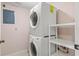 This laundry room features a stacked washer and dryer with a shelf and an access panel at 5258 Tunbridge Wells Ln # 4, Orlando, FL 32812
