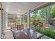 The screened-in porch offers seating and a view of the lush backyard and landscaping at 5258 Tunbridge Wells Ln # 4, Orlando, FL 32812