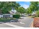 A street view of the Coach Homes at Dover Village Community entrance with manicured landscaping at 5258 Tunbridge Wells Ln # 4, Orlando, FL 32812