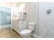 Bright bathroom featuring a white vanity, toilet, and a modern walk-in shower with white marble-look tiling at 54 Malauka Trak, Ocklawaha, FL 32179