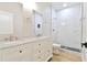 Modern bathroom with double vanity, wood-look floor, and glass shower showcasing the sleek design at 54 Malauka Trak, Ocklawaha, FL 32179
