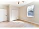 Bright bedroom with light wood floors, a double door closet, and a large window at 54 Malauka Trak, Ocklawaha, FL 32179