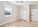 Cozy bedroom with wood-look floors, bright window, and closet space ready for rest and relaxation at 54 Malauka Trak, Ocklawaha, FL 32179