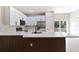 Modern kitchen featuring white cabinets, quartz countertops, a breakfast bar, and stainless steel appliances at 54 Malauka Trak, Ocklawaha, FL 32179
