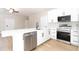 Stylish kitchen featuring stainless steel appliances, quartz countertops, and white cabinets with black hardware at 54 Malauka Trak, Ocklawaha, FL 32179