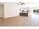 Open concept living space with modern flooring, a ceiling fan, and seamless flow into the kitchen area at 54 Malauka Trak, Ocklawaha, FL 32179