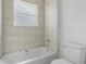Bright bathroom with tile surround in the shower-tub combo, window, and simple design at 55 Laurel Crse, Ocala, FL 34480