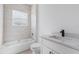 Bright bathroom featuring a tub-shower combo with tiled walls and a modern vanity with a black faucet at 55 Laurel Crse, Ocala, FL 34480