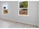 A bedroom featuring two windows that offer natural light, set against neutral walls and light floors at 55 Laurel Crse, Ocala, FL 34480