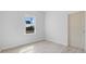 Clean, bright bedroom with a window showing the outside and light-colored, modern flooring at 55 Laurel Crse, Ocala, FL 34480