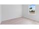 Sunlit bedroom with a view of the street through the window and sleek flooring at 55 Laurel Crse, Ocala, FL 34480