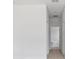 Hallway leading to a bathroom with white walls and light wood floors at 55 Laurel Crse, Ocala, FL 34480