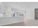 Bright, open kitchen with white cabinets, stone countertops, and modern black fixtures at 55 Laurel Crse, Ocala, FL 34480