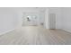 Large living room with laminated floors, white walls, lots of natural light, and a simple neutral design at 55 Laurel Crse, Ocala, FL 34480