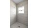 Tiled shower with a window for natural light and a modern shower head at 55 Laurel Crse, Ocala, FL 34480