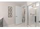 Bright bathroom with a glass-enclosed shower, framed bee artwork, and a white toilet for a clean, modern feel at 5511 Flame Vine Way, St Cloud, FL 34771