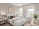 Serene bedroom with neutral tones, contemporary furnishings, large windows, and a modern chandelier at 5511 Flame Vine Way, St Cloud, FL 34771