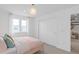 Bright bedroom with white walls, a surfboard decor, and a double window filling the space with natural light at 5511 Flame Vine Way, St Cloud, FL 34771