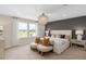 Elegant bedroom with a statement chandelier, decorative wall, and plush bedding at 5511 Flame Vine Way, St Cloud, FL 34771