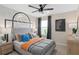 Stylized bedroom featuring vibrant wall decor, neutral furniture, and ample natural light for a warm and inviting space at 5511 Flame Vine Way, St Cloud, FL 34771