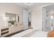 Tastefully decorated bedroom featuring a sleek dresser, ambient lighting, and doorway to the bathroom at 5511 Flame Vine Way, St Cloud, FL 34771