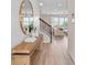 Bright entryway showcasing a stylish mirror, wooden bench, and staircase to the upper level at 5511 Flame Vine Way, St Cloud, FL 34771