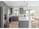 Spacious kitchen featuring stainless steel appliances, gray cabinets, and a view of the pool through sliding glass doors at 5511 Flame Vine Way, St Cloud, FL 34771