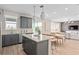 Open concept living area with a kitchen island, dining table, and a stylishly furnished living room at 5511 Flame Vine Way, St Cloud, FL 34771