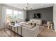 Cozy living room with a large window, comfortable seating, modern lighting, and stylish decor at 5511 Flame Vine Way, St Cloud, FL 34771