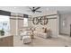 Cozy living room with a ceiling fan, a comfortable sectional sofa, and decorative shelving at 5511 Flame Vine Way, St Cloud, FL 34771
