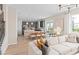 Open-concept living space flowing into the dining area and kitchen, filled with natural light at 5511 Flame Vine Way, St Cloud, FL 34771