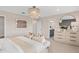 Bright main bedroom showcasing a stylish chandelier, ensuite bathroom, and neutral color palette for a relaxing ambiance at 5511 Flame Vine Way, St Cloud, FL 34771