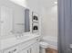 Clean bathroom featuring a white vanity, framed mirror, and a shower with a patterned curtain at 5517 Flame Vine Way, St Cloud, FL 34771