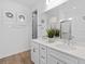 Bright bathroom with double sinks, white cabinets, and modern fixtures at 5517 Flame Vine Way, St Cloud, FL 34771