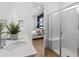 Bright bathroom with double sinks, quartz countertop, a glass shower, and a bedroom view at 5517 Flame Vine Way, St Cloud, FL 34771