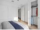 Bright bedroom featuring a closet, wood flooring, and a bed with blue accents at 5517 Flame Vine Way, St Cloud, FL 34771