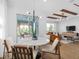 Dining area with a round table and a sliding door to an outdoor pergola at 5517 Flame Vine Way, St Cloud, FL 34771