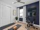 Well-lit exercise room with a ceiling fan, hardwood floors, a window, and workout equipment at 5517 Flame Vine Way, St Cloud, FL 34771