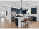 Beautiful kitchen with stainless steel appliances, island, and dark blue cabinets at 5517 Flame Vine Way, St Cloud, FL 34771