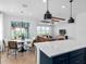 Open concept living space boasts modern light fixtures, dining area, and wood-look flooring at 5517 Flame Vine Way, St Cloud, FL 34771