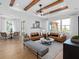 Open-concept living room featuring stylish furnishings, wood beams, and lots of natural light at 5517 Flame Vine Way, St Cloud, FL 34771