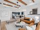 Open-concept living space featuring a kitchen island, modern lighting, and stylish furniture at 5517 Flame Vine Way, St Cloud, FL 34771