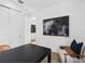 Comfortable office with a sleek black desk, art, and a cozy accent chair at 5517 Flame Vine Way, St Cloud, FL 34771