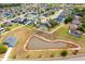 Picturesque aerial view highlights homes with pools and lush greenery surrounding a peaceful pond within a Gathering-friendly community at 563 Copperdale Ave, Winter Garden, FL 34787