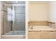 Bright bathroom features a tiled tub with mosaic accents and a frameless glass-enclosed shower at 563 Copperdale Ave, Winter Garden, FL 34787