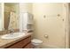 Bathroom with sink, toilet, cabinet, and shower at 563 Copperdale Ave, Winter Garden, FL 34787