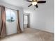 Bedroom showing a round window and a traditional window, neutral carpet, and natural light at 563 Copperdale Ave, Winter Garden, FL 34787
