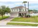 Lovely home featuring a brick driveway, two-car garage, and a beautifully landscaped front yard at 563 Copperdale Ave, Winter Garden, FL 34787