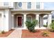 Inviting front porch with decorative columns and seating area at 563 Copperdale Ave, Winter Garden, FL 34787