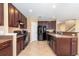 Spacious kitchen featuring dark cabinets, tile floors, and modern appliances at 563 Copperdale Ave, Winter Garden, FL 34787